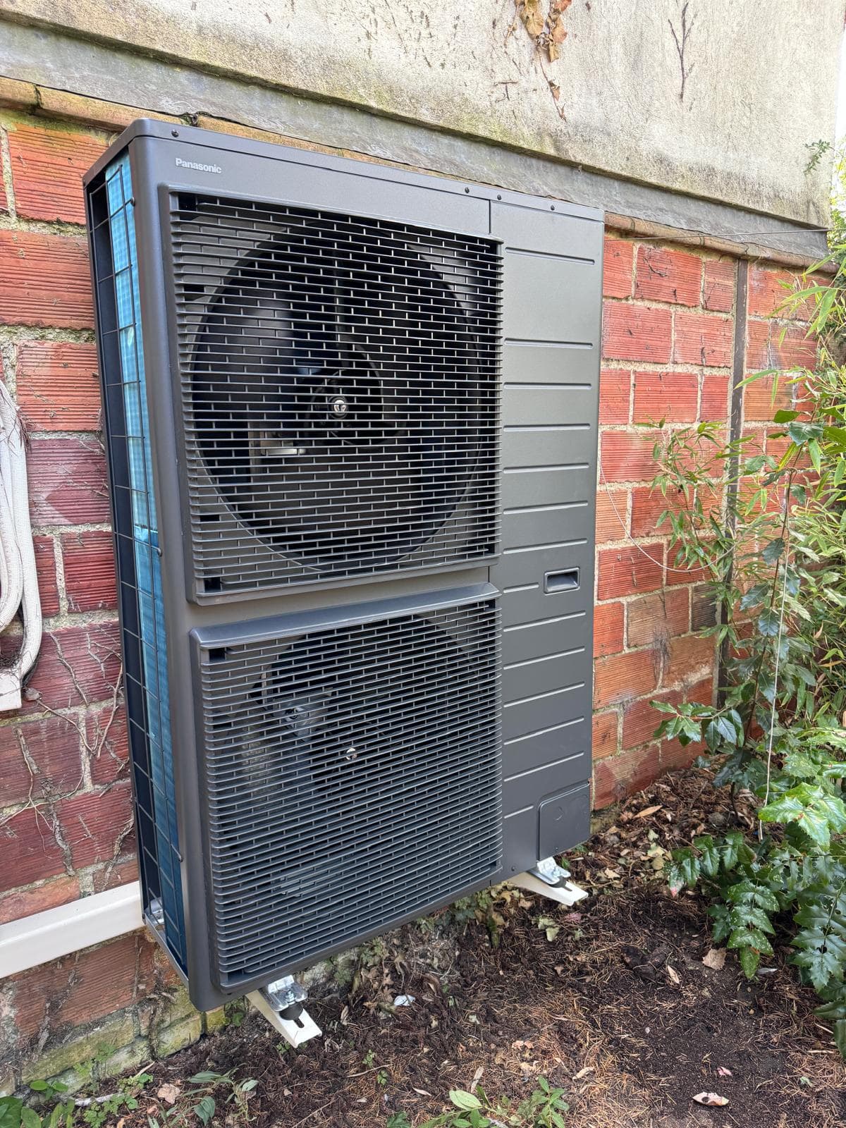 Unité extérieure PAC jardin installation soignée